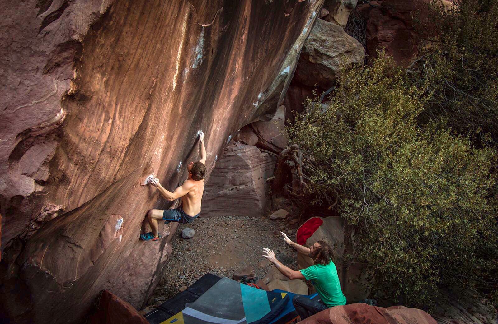 Chris Sharma spots Pol Roca on a boulder problem in Red Rocks, just outside of Las Vegas, NV. Photo: Ricardo Giancola.